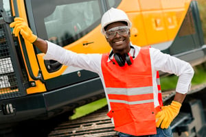 Construction worker with a crane in the background